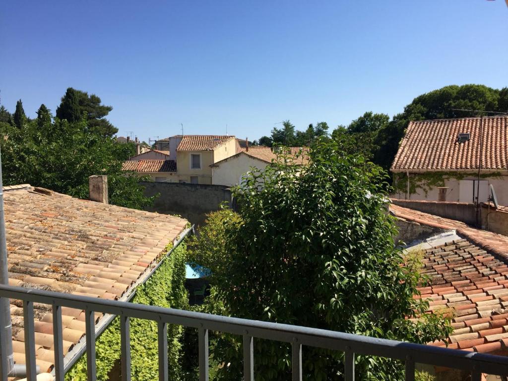 a view from the balcony of a town with roofs at Le cœur d'Orques in Saint-Georges-dʼOrques