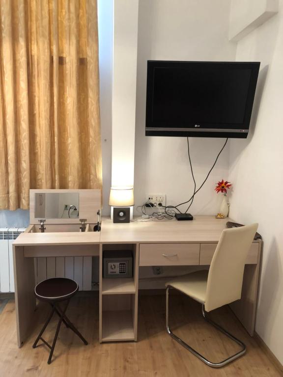 a computer desk with a monitor and a chair at Budapest Digital Nomad Friendly Top Centre Apt in Sofia