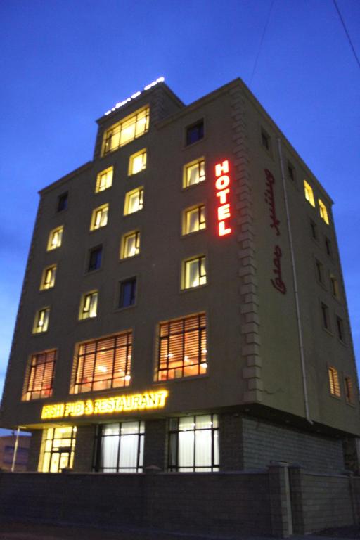 a building with a sign on the side of it at Baigal Hotel in Ulaanbaatar
