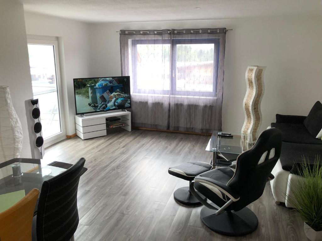 a living room with a couch and a tv at Ferienwohnungen Gassmann in Schutterzell