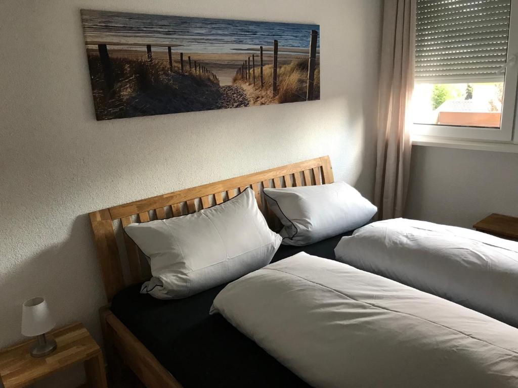 um quarto com duas camas e um quadro na parede em Ferienwohnung *stadtnah* ruhig* modern em Ravensburg