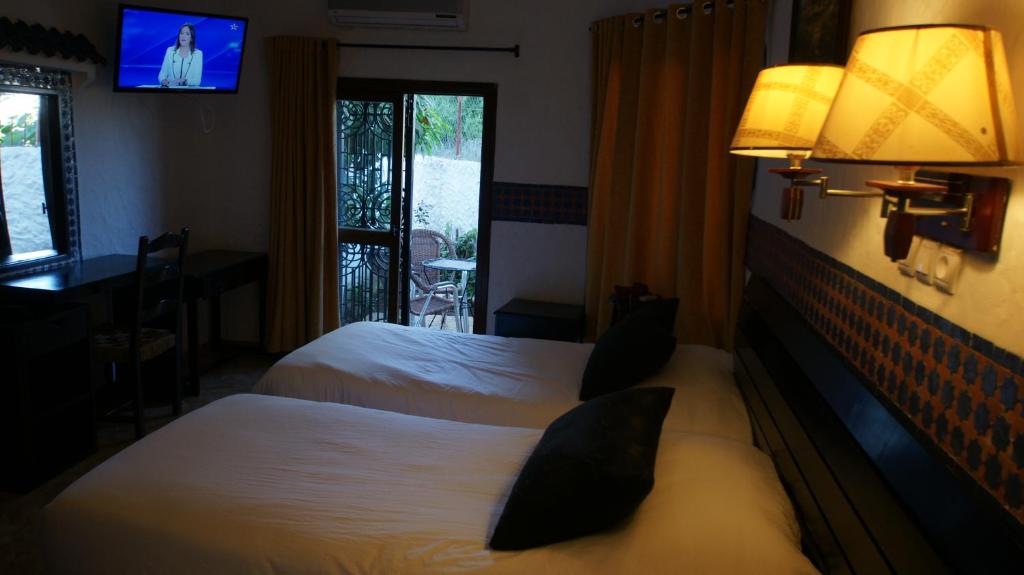 Postel nebo postele na pokoji v ubytování Hotel Hacienda