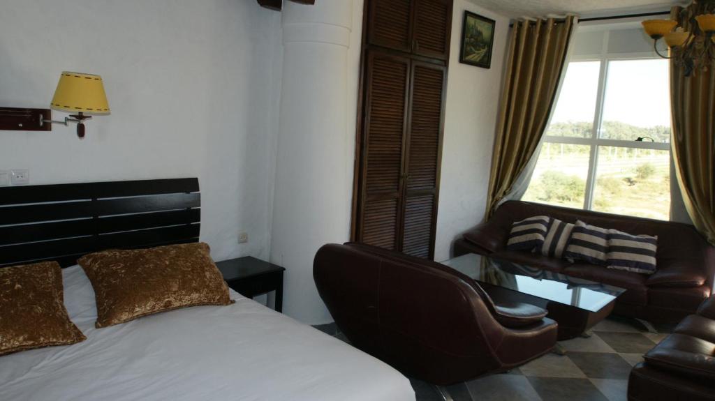 Postel nebo postele na pokoji v ubytování Hotel Hacienda