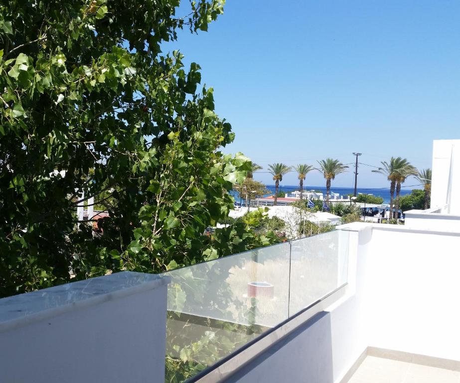 a view of the beach from the balcony of a house at Ria's Deluxe Apartments in Faliraki