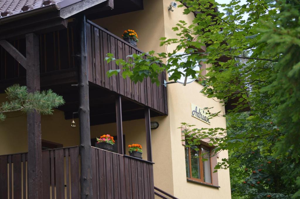 a building with two balconies with flowers on them at Chata Adrian Slovak Paradise in Spišské Tomášovce