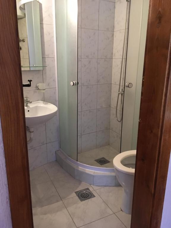 a bathroom with a shower and a toilet and a sink at Apartment Klara in Bar