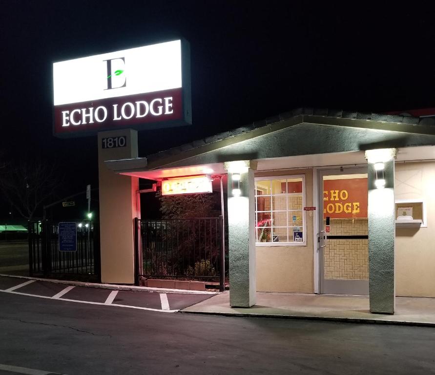 a store with a sign that reads echo lodge at night at Echo Lodge in West Sacramento