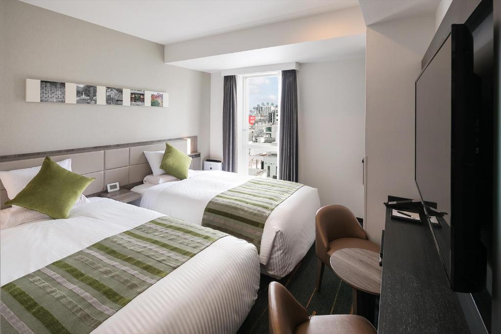 Postel nebo postele na pokoji v ubytování Hotel Mystays Nagoya Nishiki