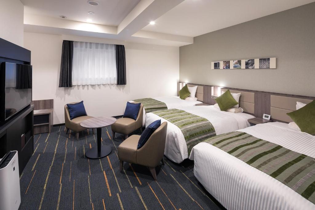 Postel nebo postele na pokoji v ubytování Hotel Mystays Nagoya Nishiki