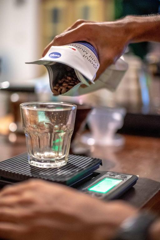a person is pouring a drink into a glass at Snooze in Yogyakarta