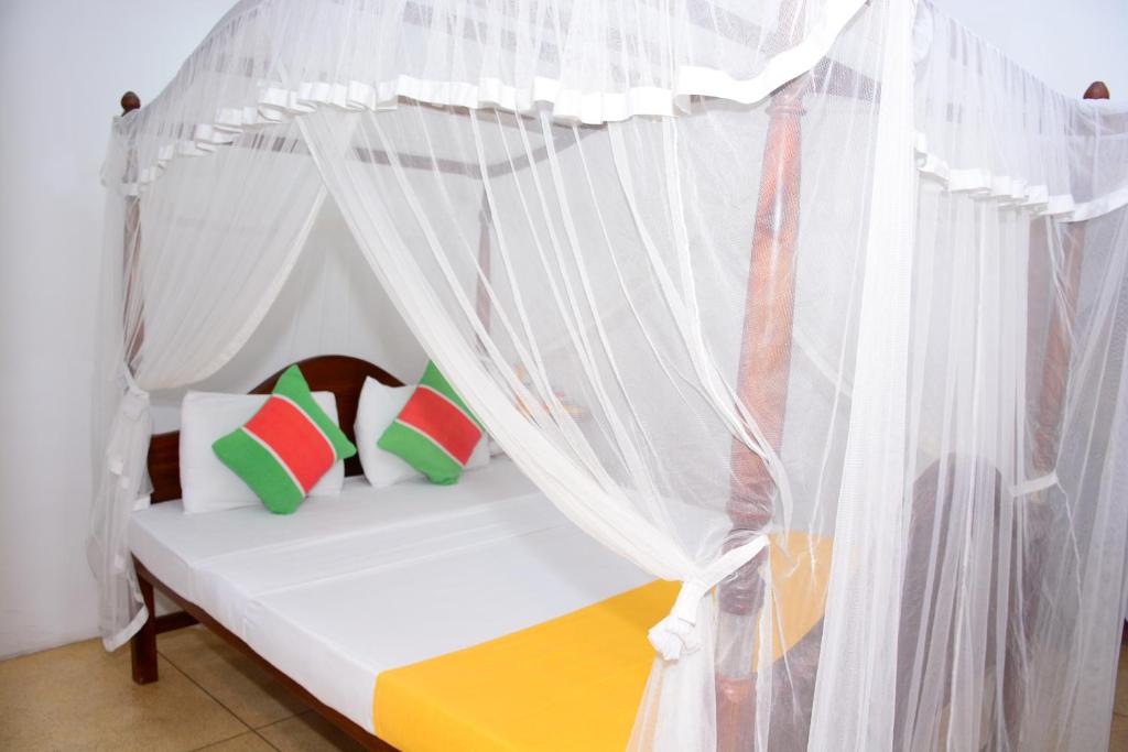 a bed with a canopy in a room at Kabalana Design House Villa in Ahangama