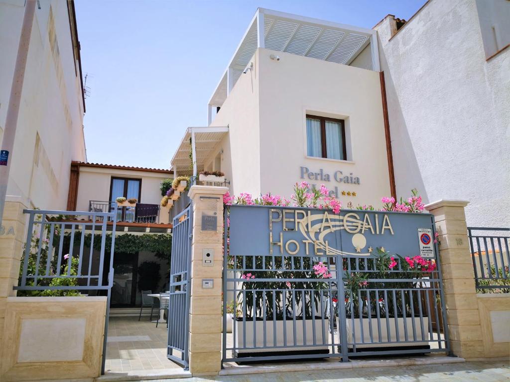 a hotel with a gate in front of a building at Hotel Perla Gaia in San Vito lo Capo