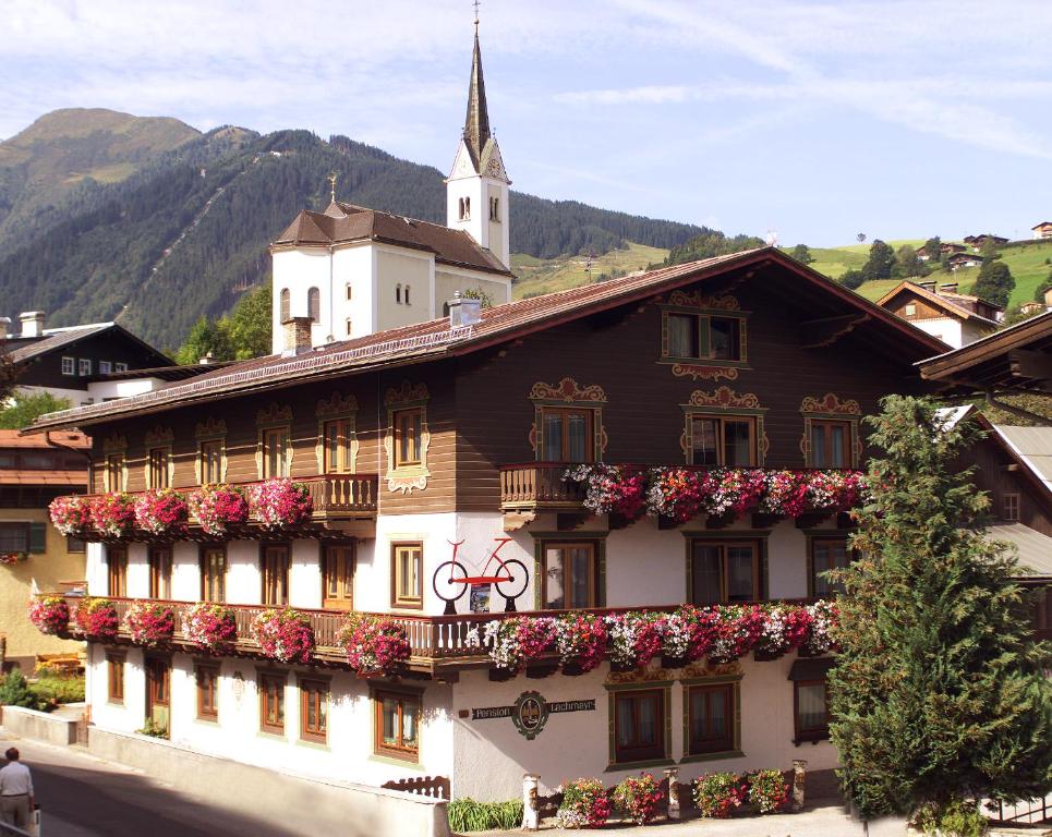 a building with flowers on the side of it at Pension Lachmayr in Kaprun