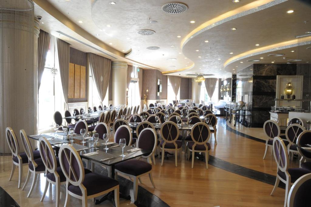 a banquet hall with tables and chairs in a room at Limak Eurasia Luxury Hotel in Istanbul