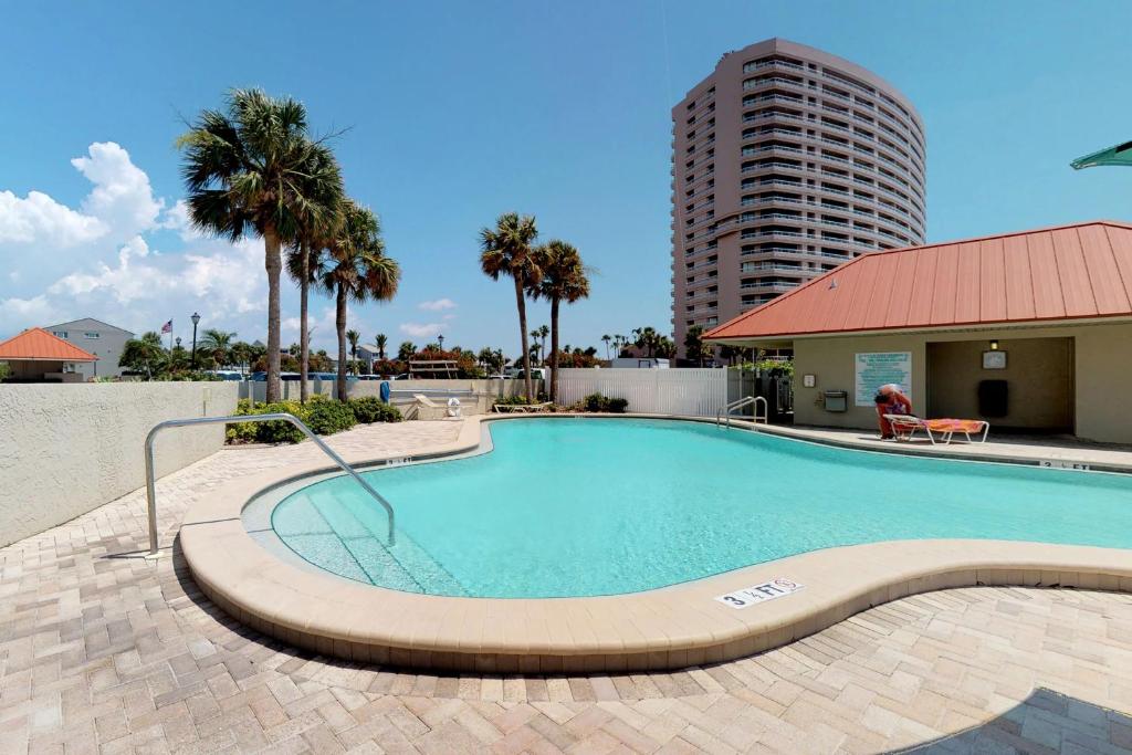 a large swimming pool with a building in the background at Lighthouse Towers Condominium in Clearwater Beach
