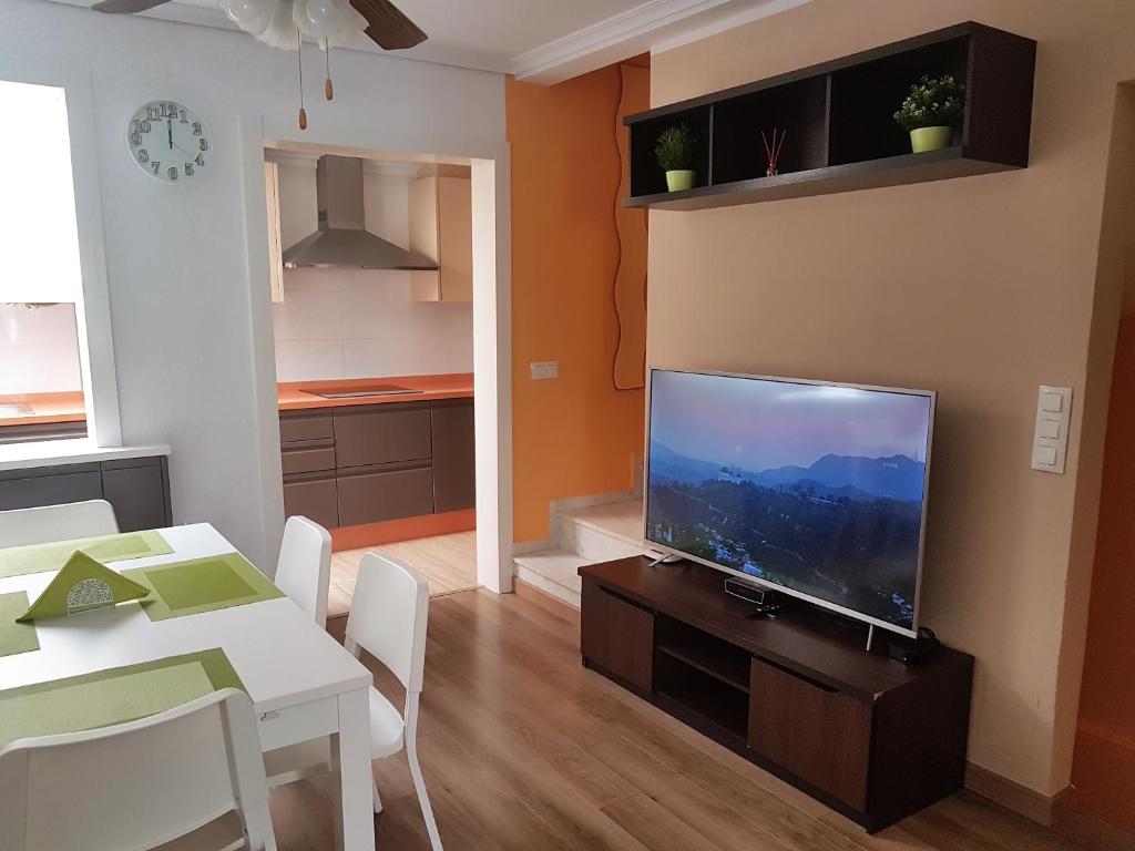 a living room with a flat screen tv on a table at Globus Gran Alacant in Santa Pola