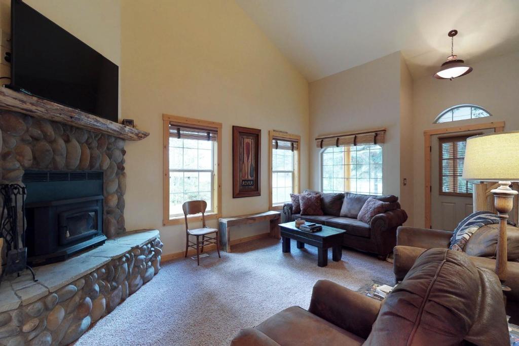 a living room with a couch and a fireplace at Rio Vista Family Cabin in McCall