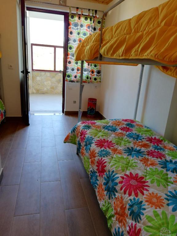 a bedroom with a bed and a bunk bed at Sol Mar in Odeceixe