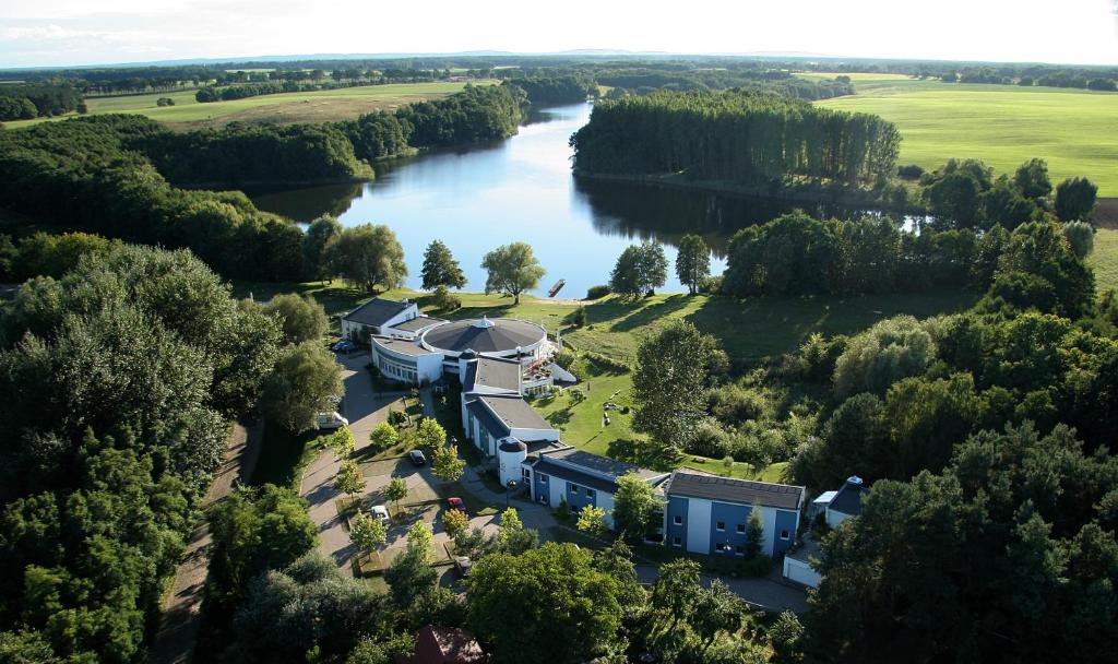 an aerial view of a house next to a river at Seehotel Luisenhof in Falkenhagen