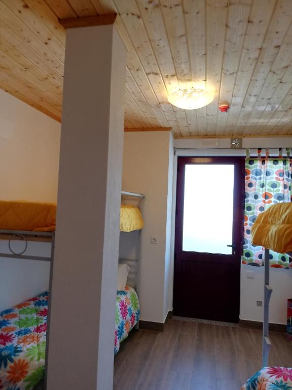 a dorm room with two beds and a door at Sol Mar in Odeceixe