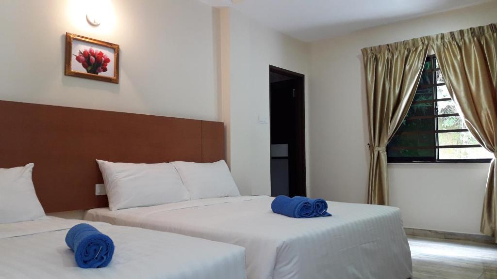Postel nebo postele na pokoji v ubytování TULIP HOTEL & APARTMENT