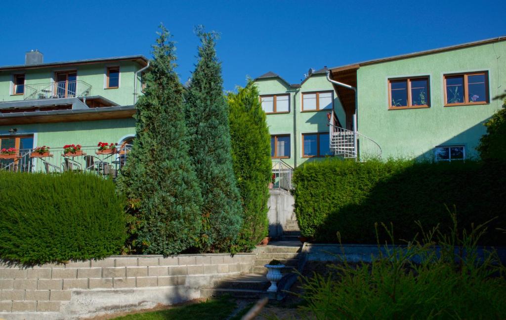 a row of houses with trees in front of them at Pension Lukas in Karlovy Vary