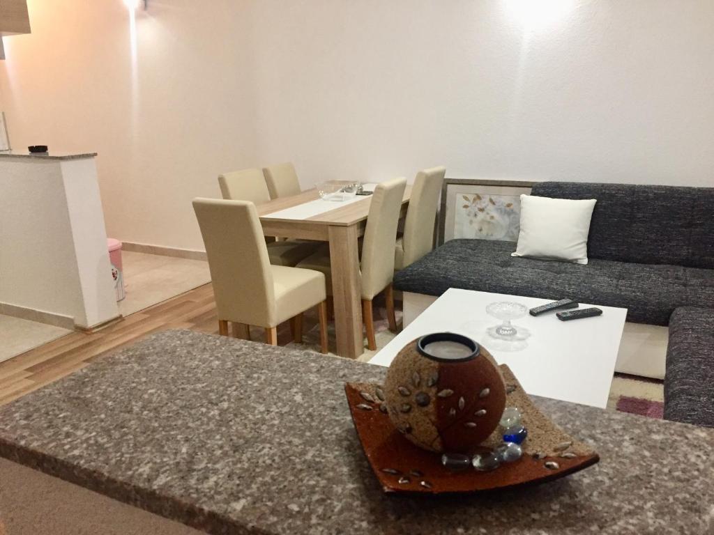 a living room with a couch and a table at Apartman AS in Bihać