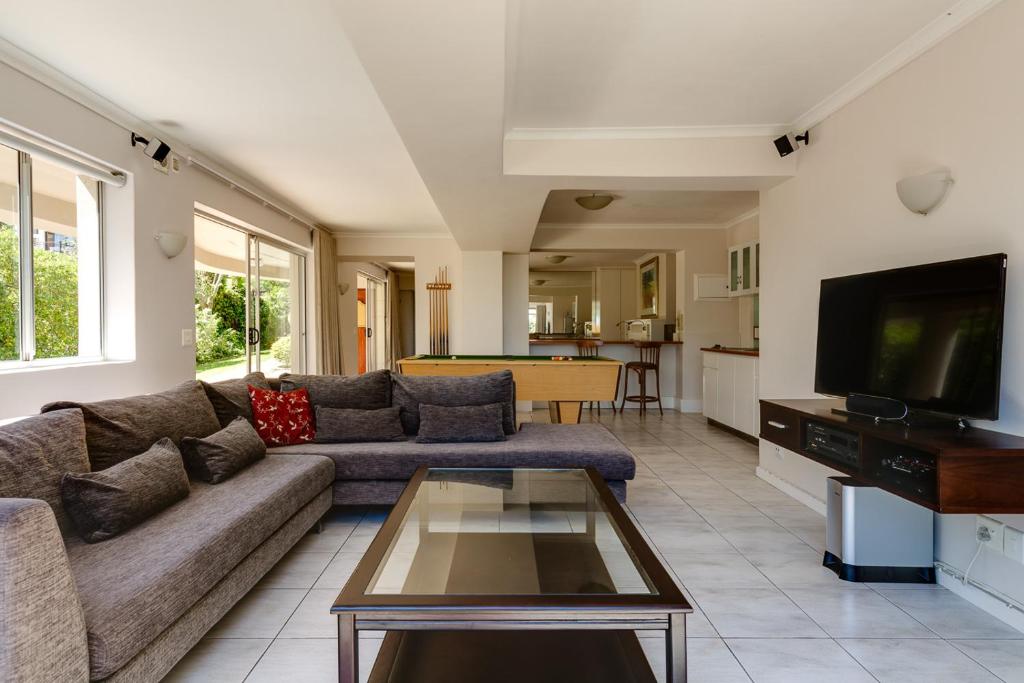 a living room with a couch and a tv at 42 On Strathmore in Cape Town
