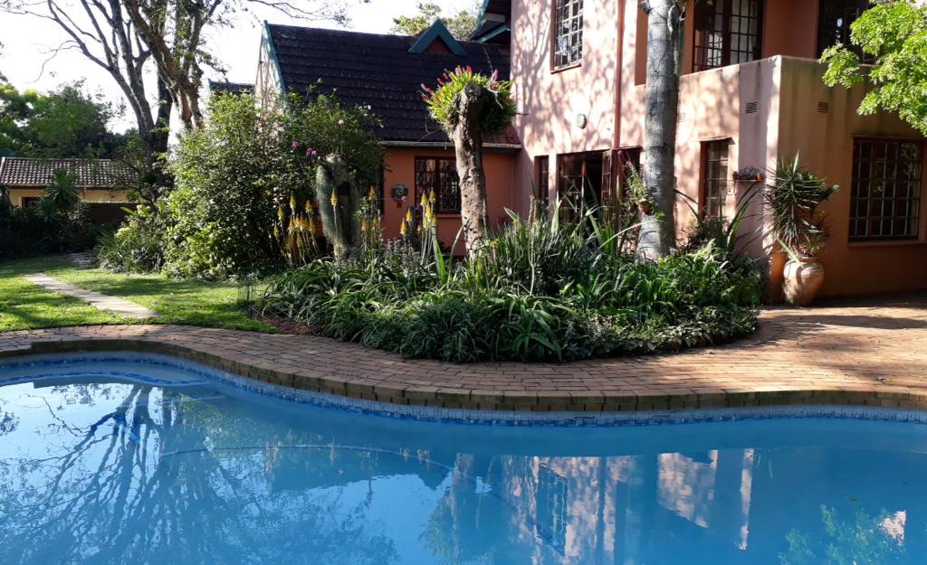 a swimming pool in front of a house at Mtunzini BnB in Mtunzini