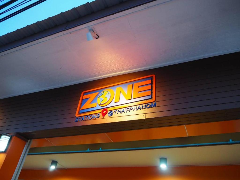 a neon sign on the side of a building at Zone Stations -That Phanom in That Phanom