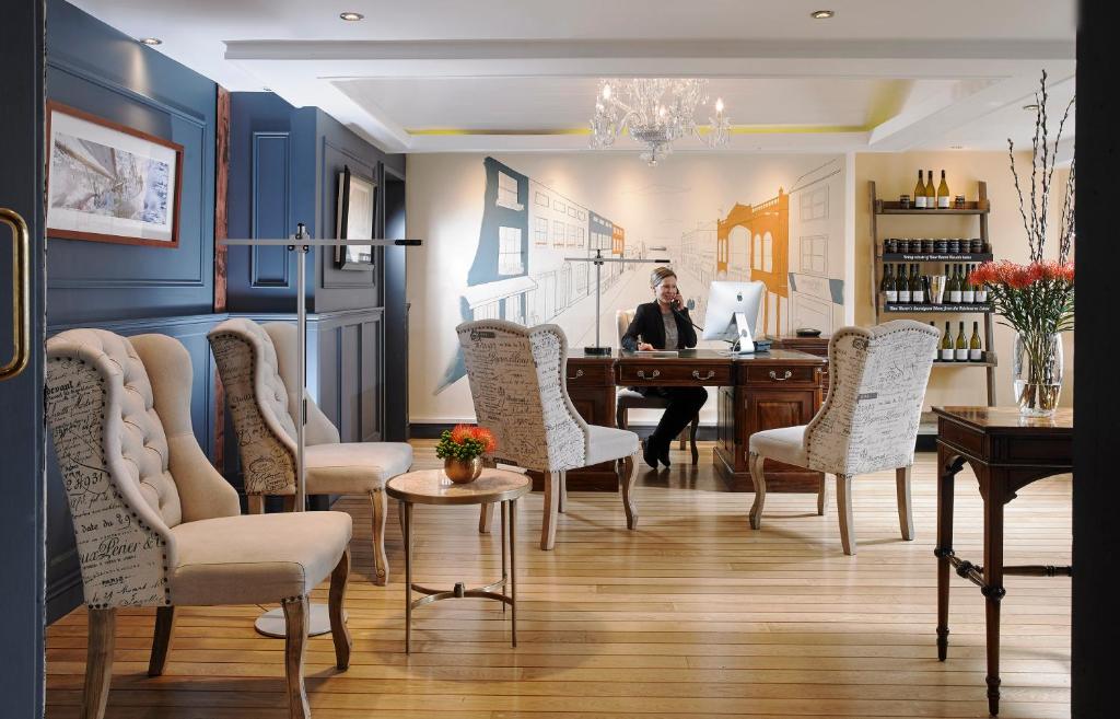 a man sitting at a table in a room at The Blue Haven Hotel in Kinsale