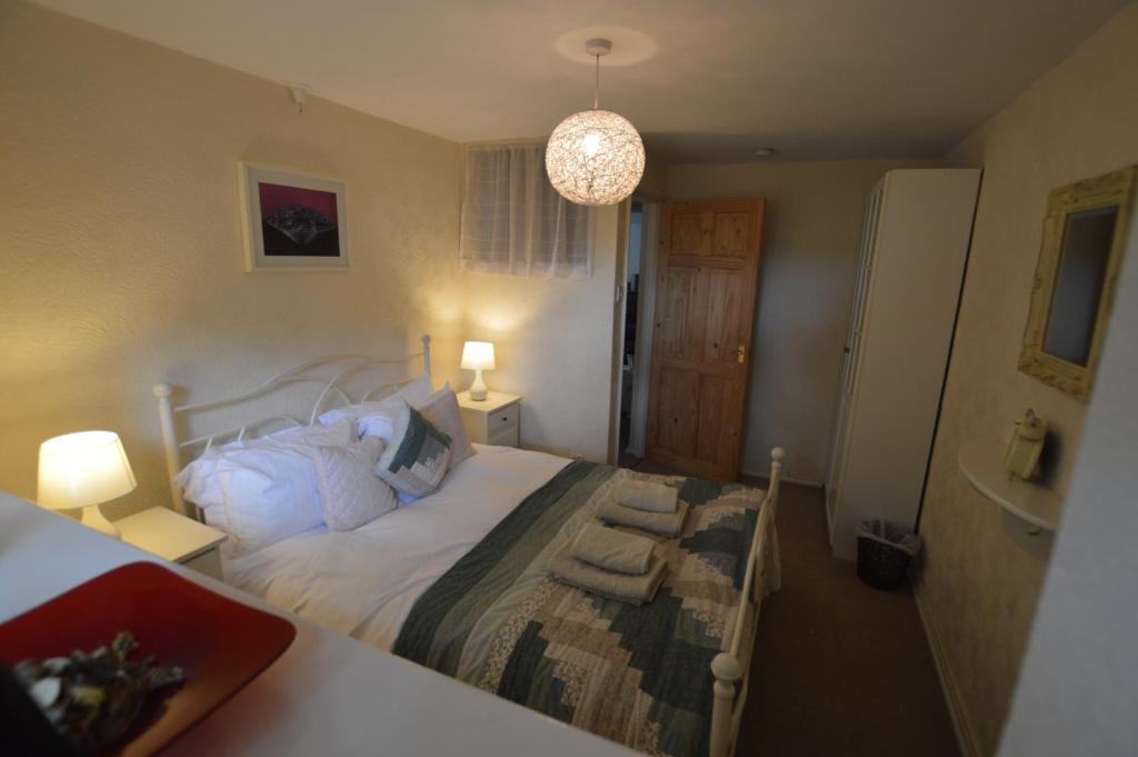 a bedroom with a bed and two lamps and a sink at Fox Barn in Staveley