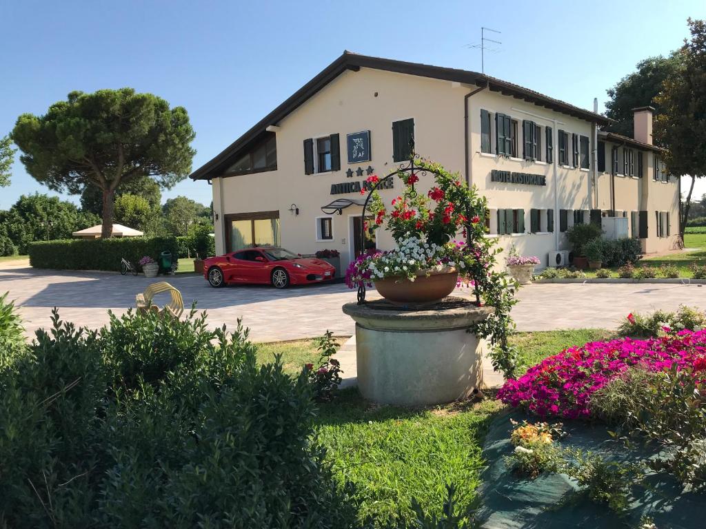 a building with a pot of flowers in a yard at Hotel Antica Fenice in Campalto