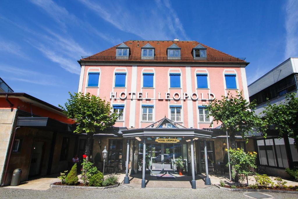 a building with a sign on the front of it at Hotel Leopold in Munich
