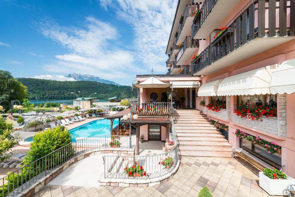 un hotel con piscina y un edificio en Hotel Ariston en Levico Terme