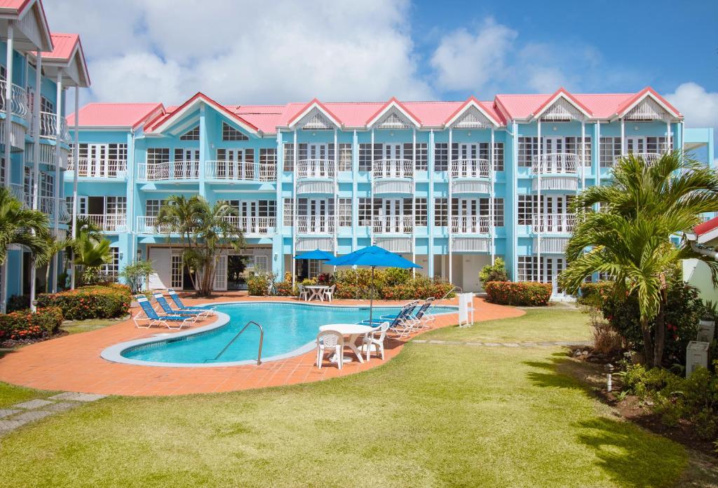 an exterior view of a resort with a swimming pool at Bay Gardens Marina Haven in Gros Islet