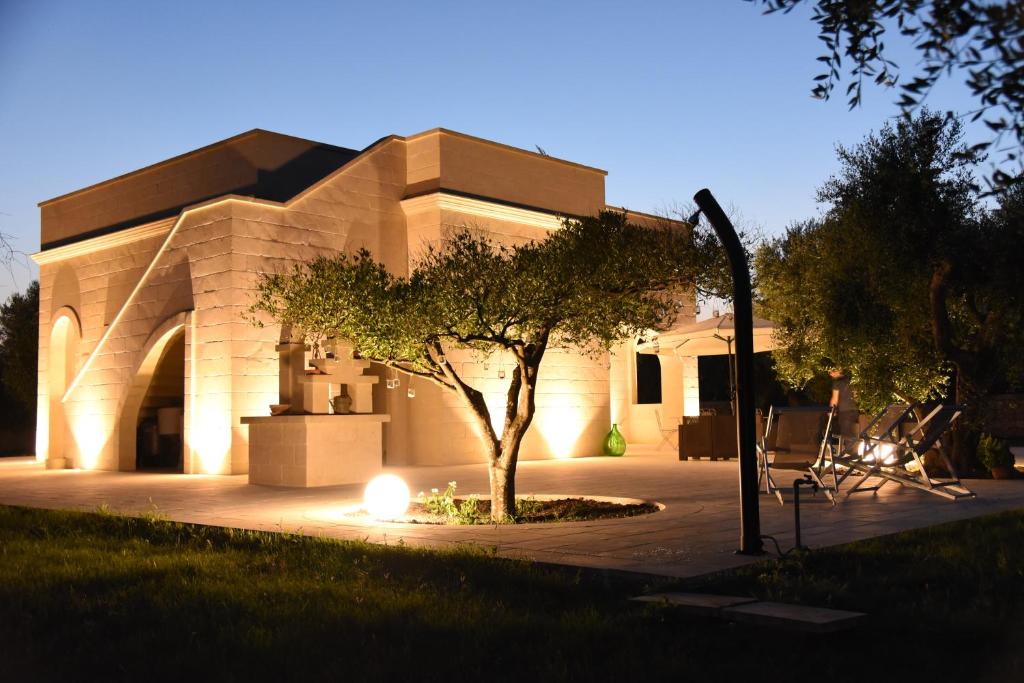 a building with a tree in front of it at Tenuta Buonasorte in Torre dell'Orso