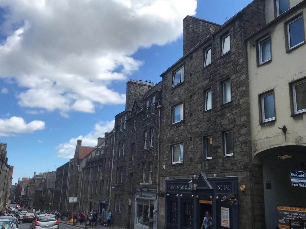 a row of tall brick buildings on a city street at Crags View Apartment On The Royal Mile in Edinburgh