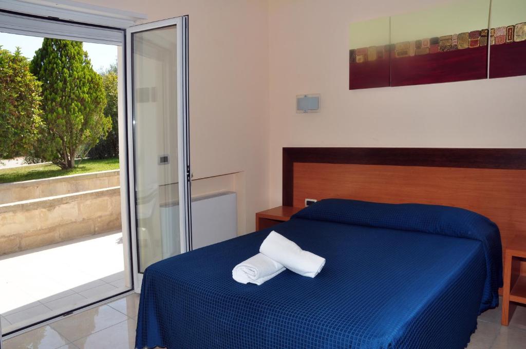 Postel nebo postele na pokoji v ubytování Hotel Club Koiné