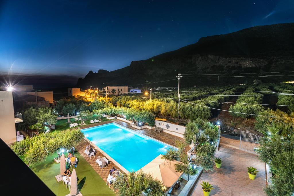 an overhead view of a swimming pool at night at Hotel Achibea in San Vito lo Capo