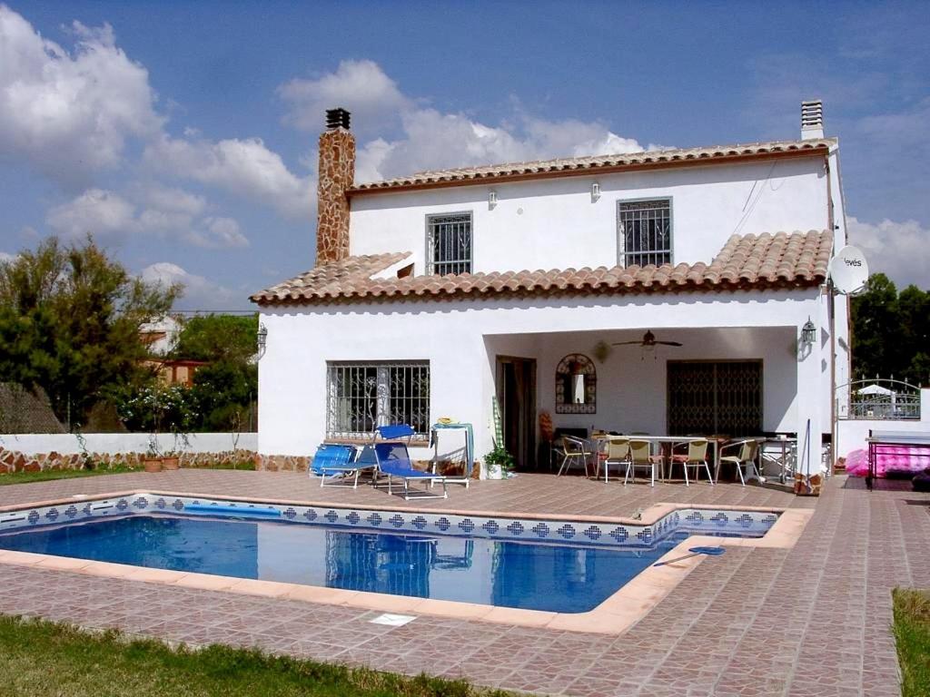 a villa with a swimming pool in front of a house at Casa del Arte in L'Ametlla de Mar
