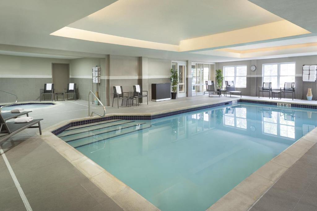 a large swimming pool in a hotel room at Cambridge Suites Mississauga in Mississauga