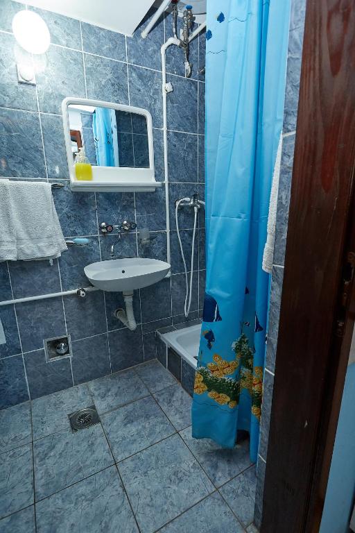 a bathroom with a sink and a toilet and a shower at Apartmani Malica in Soko Banja