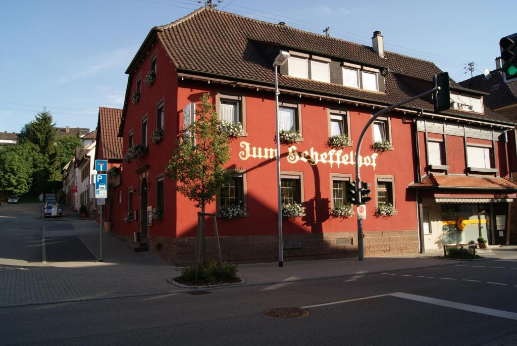 a red building on the corner of a street at Zum Scheffelhof in Maulbronn