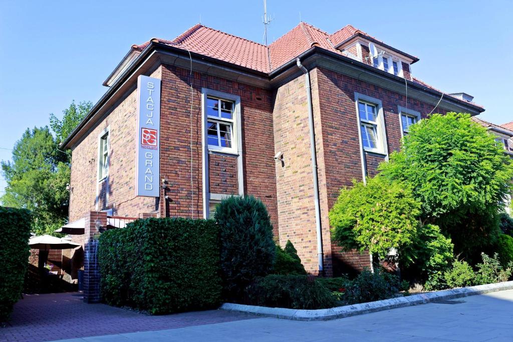 a brown brick building with a red roof at Stacja Grand in Szczecin