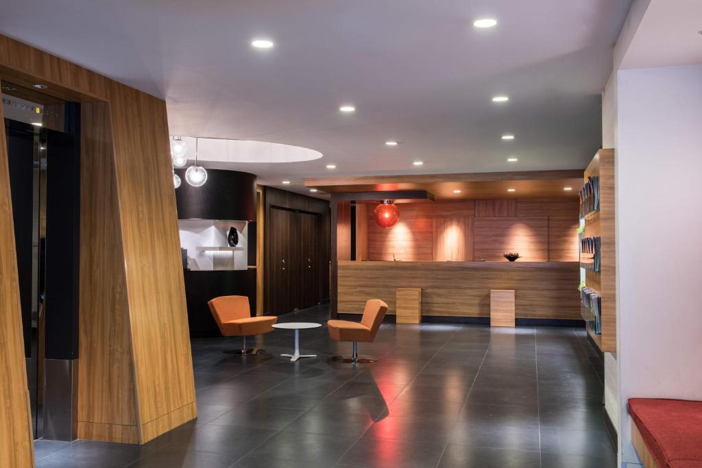 a lobby with chairs and a table in a building at the b ikebukuro in Tokyo
