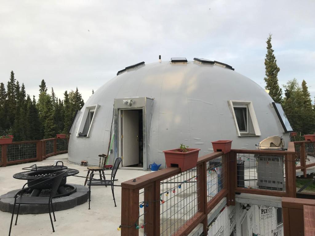 a dome house on a deck with a patio at Delta Dome Home Basement Apartment in Delta Junction