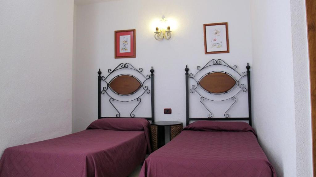 Postel nebo postele na pokoji v ubytování Bungalows Rebecca Park