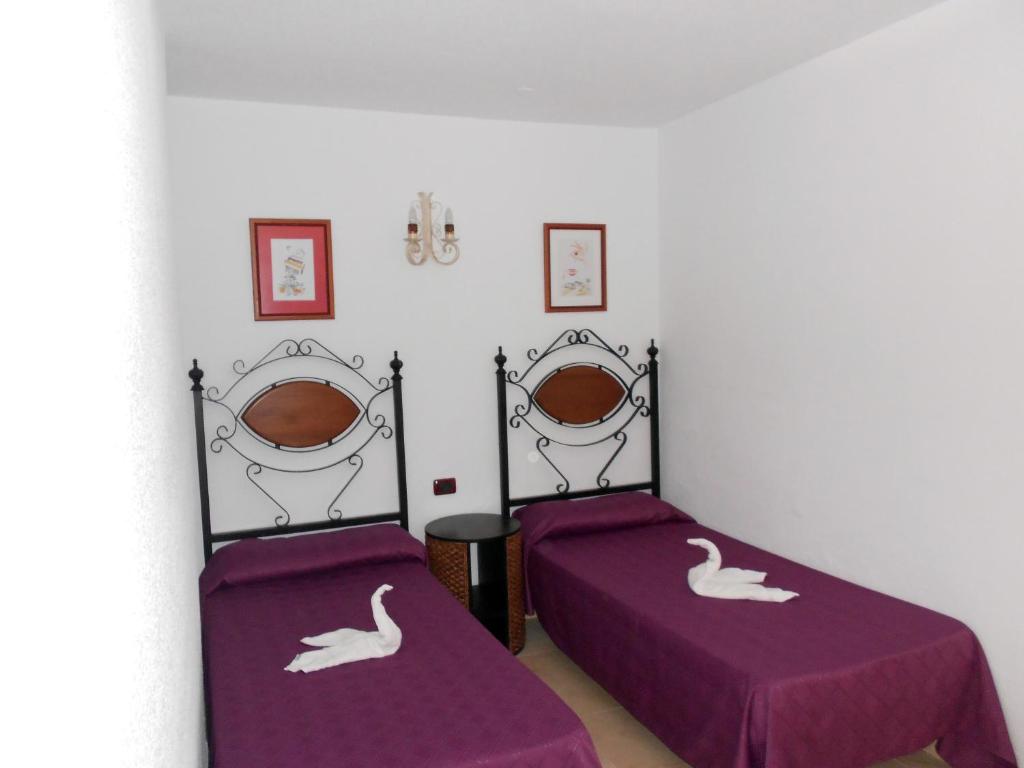 Postel nebo postele na pokoji v ubytování Bungalows Rebecca Park