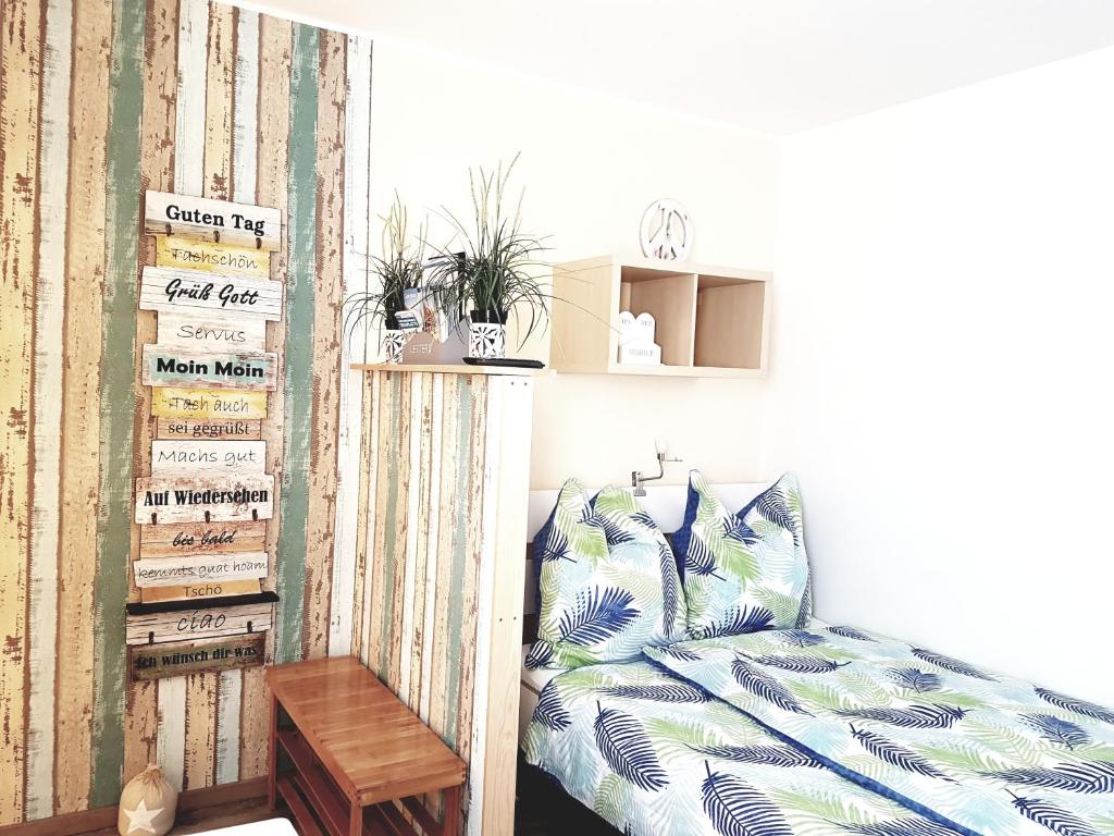 a bedroom with a bed and a shelf with plants at Studio 35 (Waren Müritz) in Waren